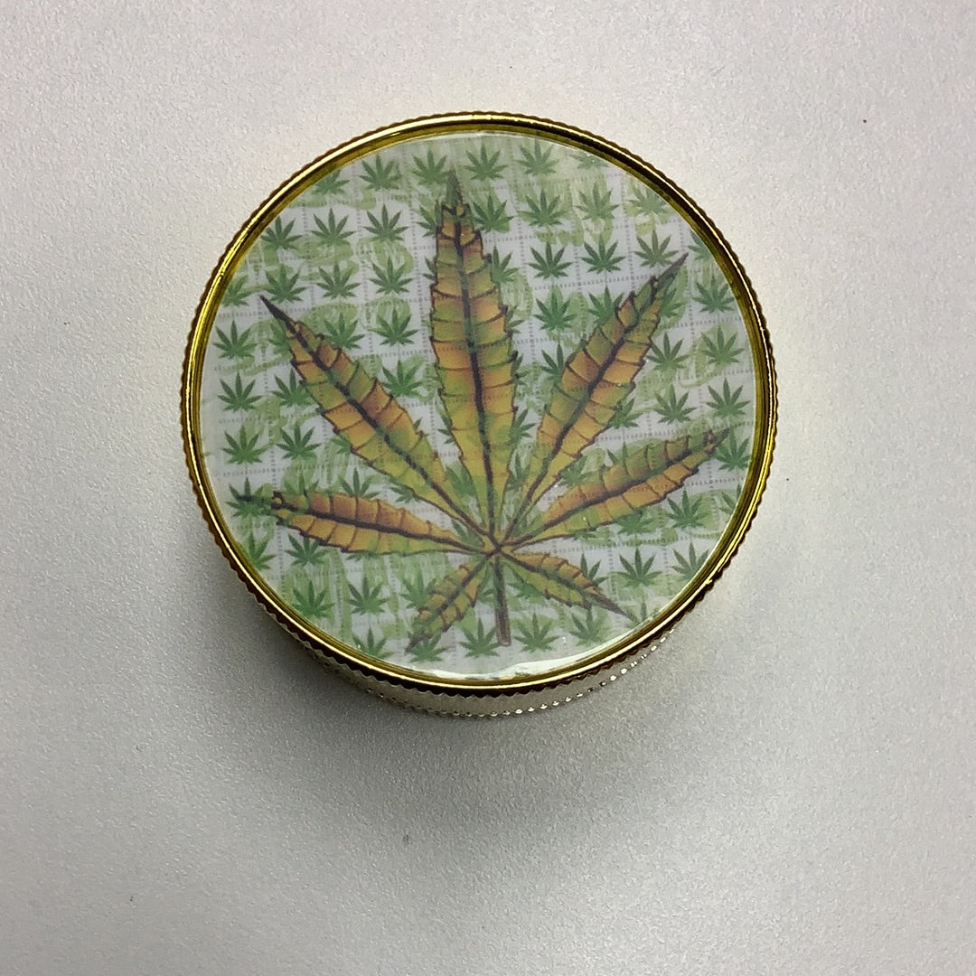 Canna Leaf Gold 2 Inch Metal Grinder yoga smokes yoga studio, delivery, delivery near me, yoga smokes smoke shop, find smoke shop, head shop near me, yoga studio, headshop, head shop, local smoke shop, psl, psl smoke shop, smoke shop, smokeshop, yoga, yoga studio, dispensary, local dispensary, smokeshop near me, port saint lucie, florida, port st lucie, lounge, life, highlife, love, stoned, highsociety. Yoga Smokes
